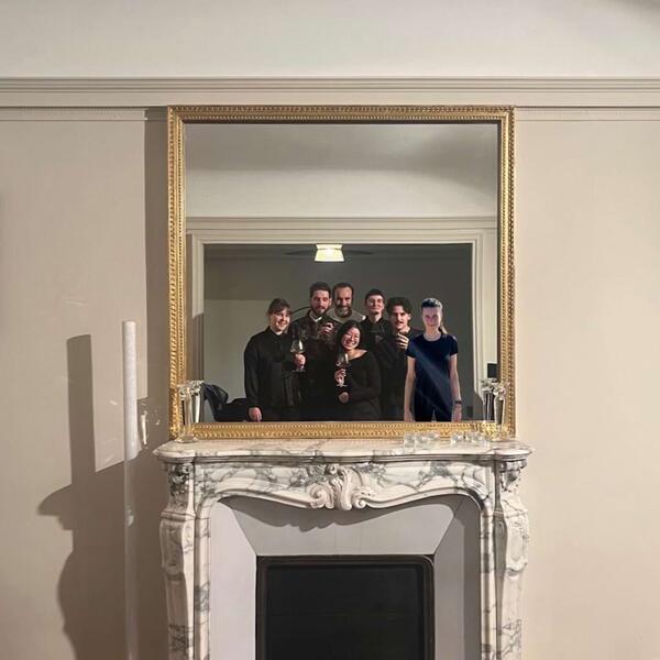 People standing in front of a mirror