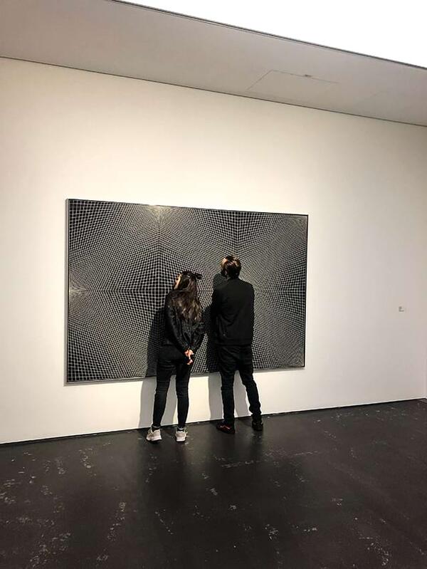 people standing in an exhibition